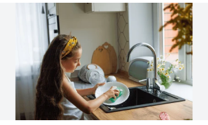 young girl washing dishes
